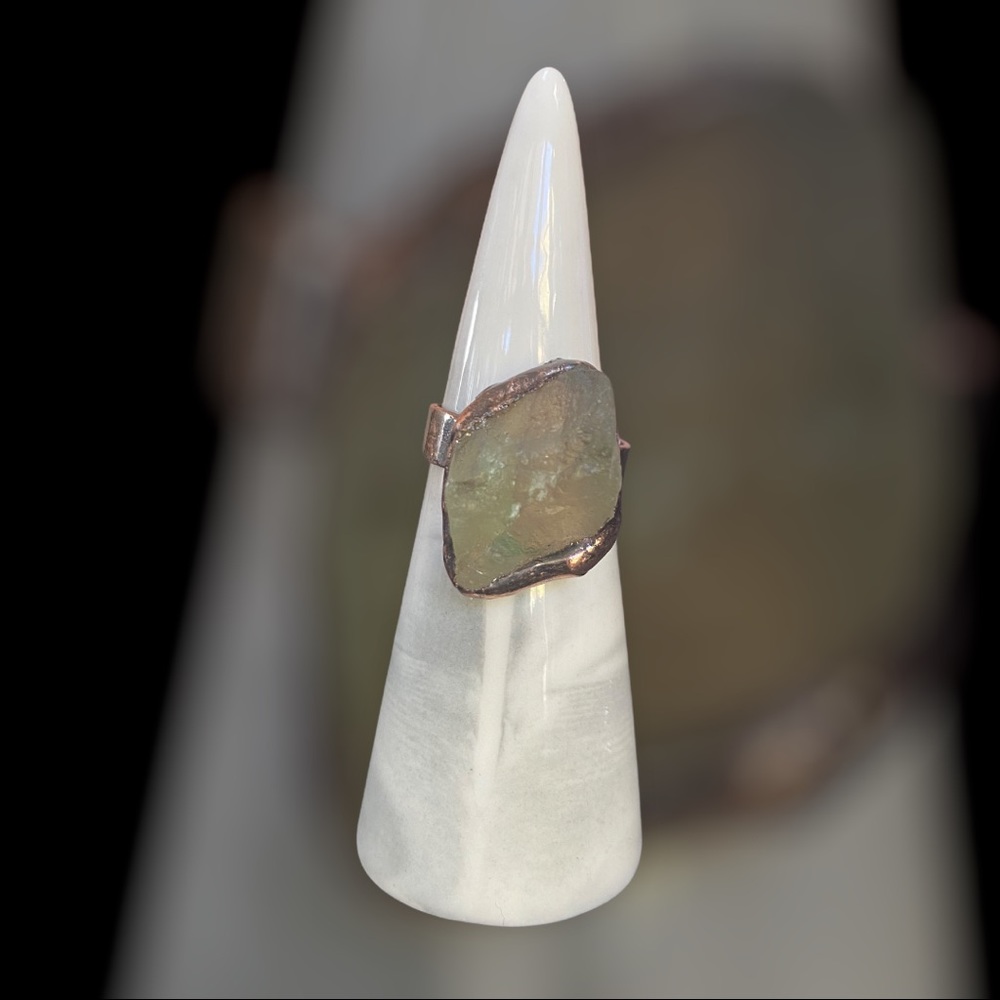 Raw edge green stone ring set in bronze.